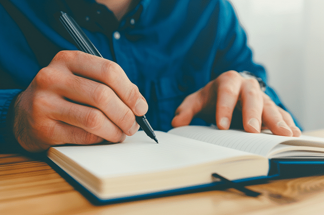 Man writing in notebook